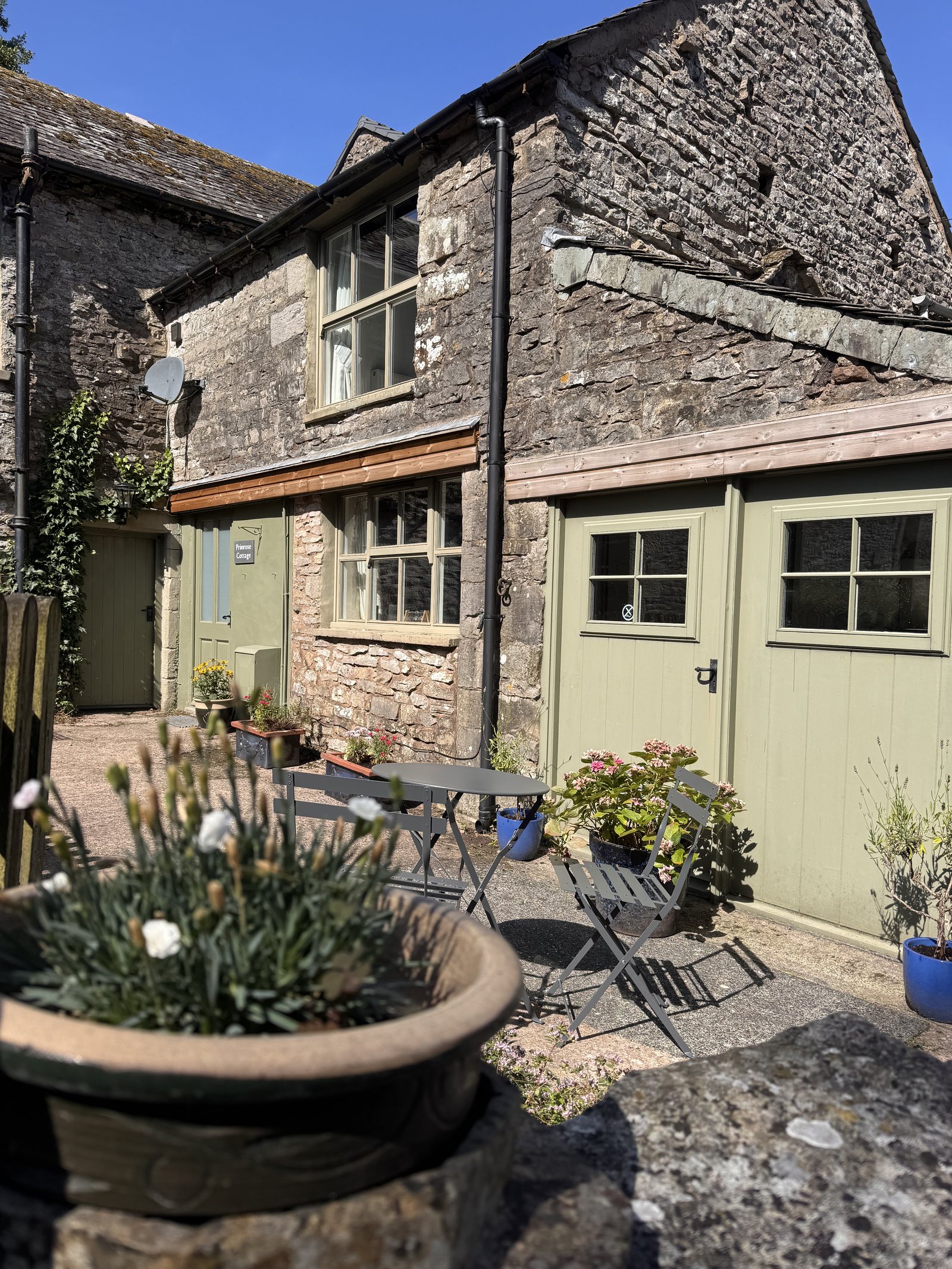 Primrose Cottage — side view with patio seating