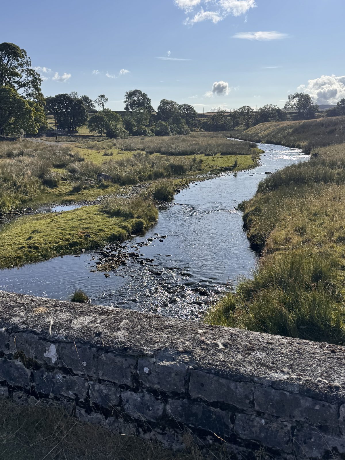 Riverside walk over a stone bridge near Shap